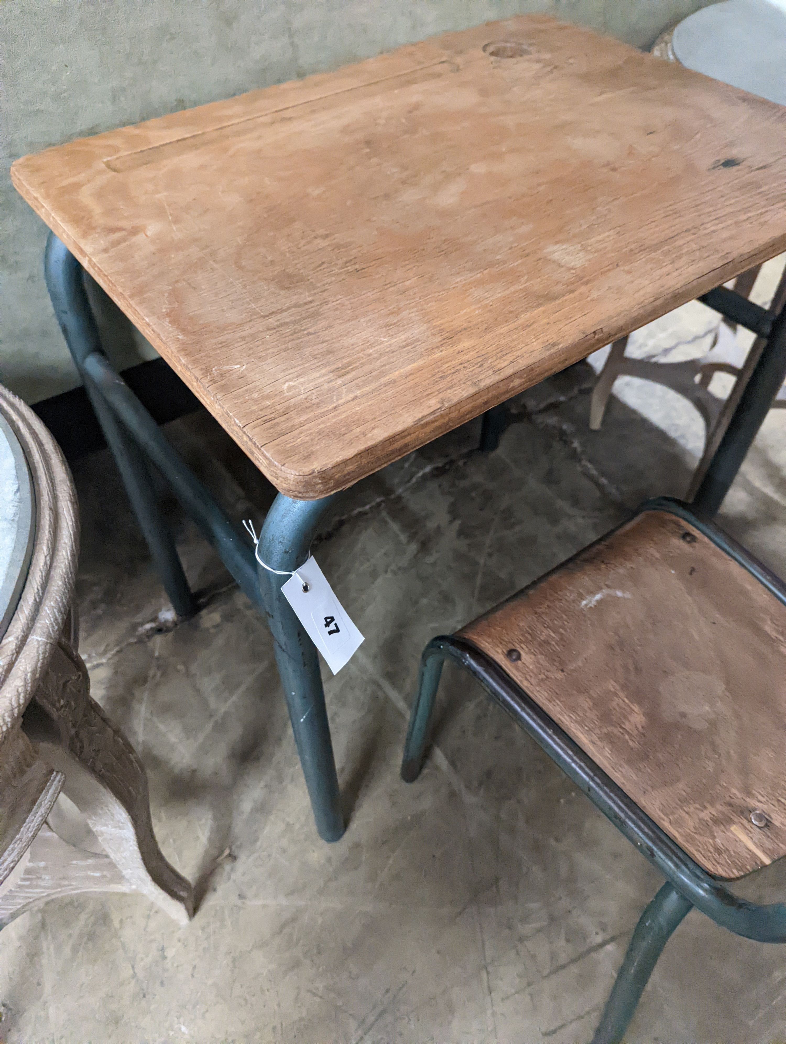 A child's oak and painted metal desk, length 59cm, depth 45cm, height 64cm and a chair